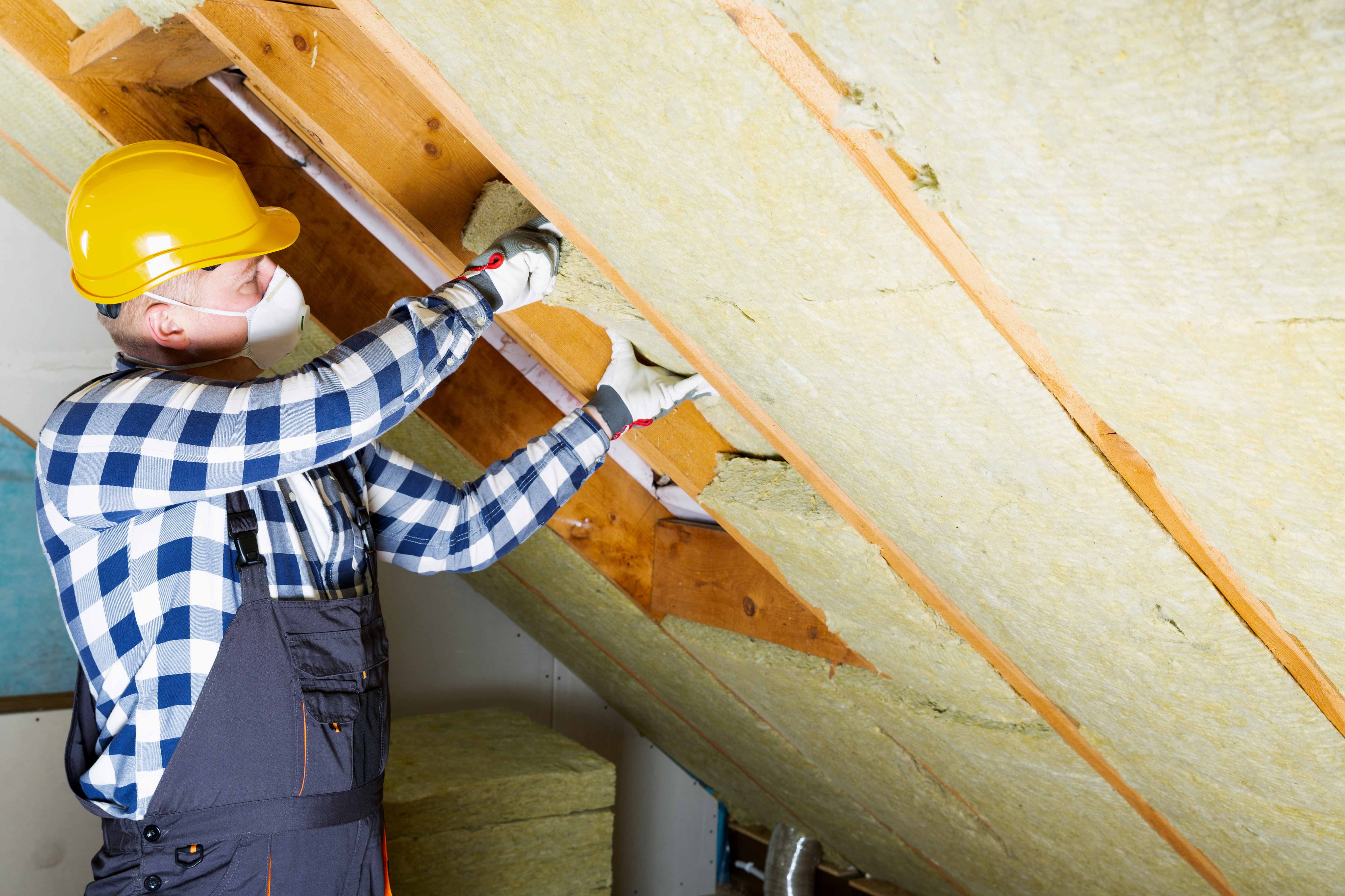 Man installing thermal roof insulation layer