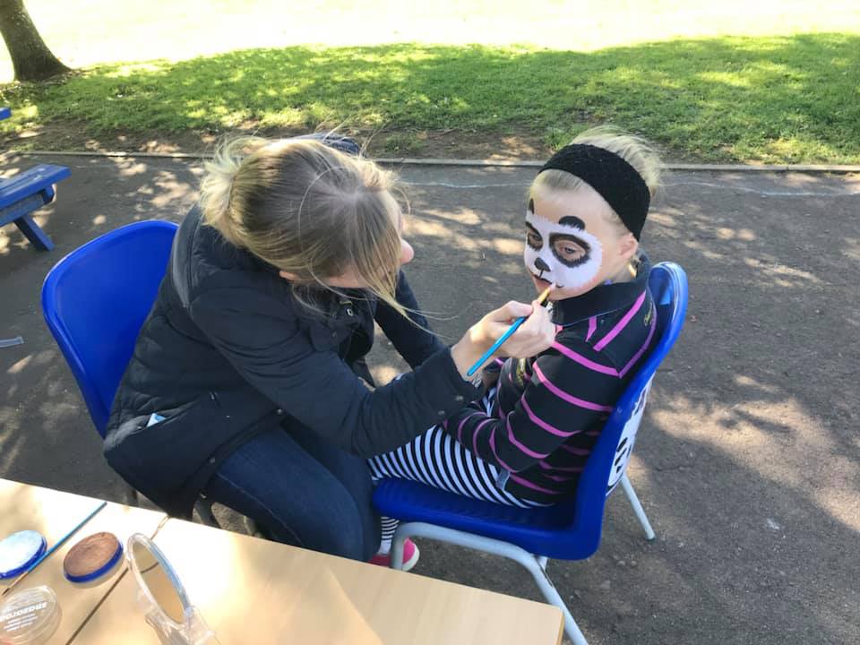 Child having their face painted