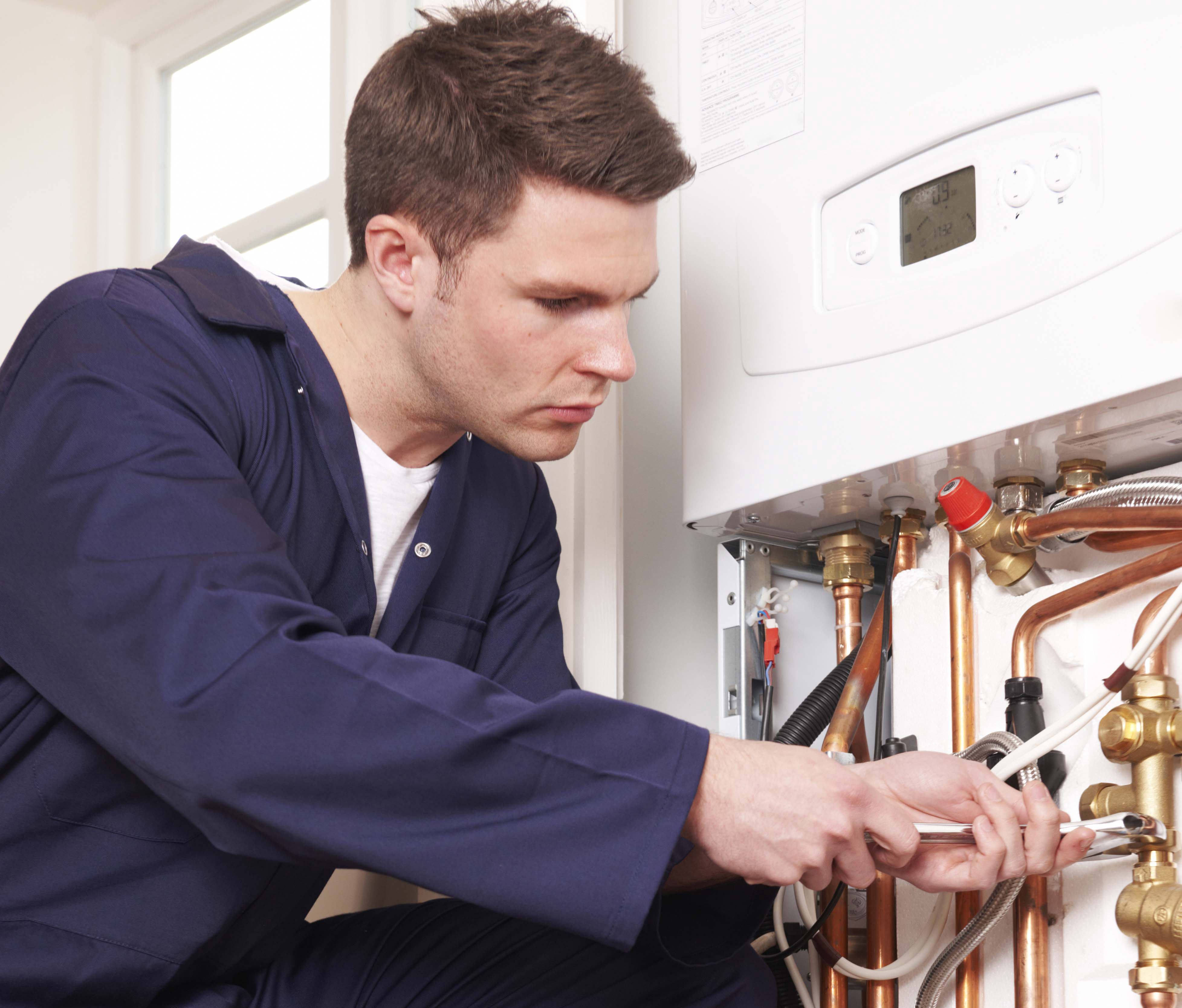 Gas engineer servicing a boiler in time for winter