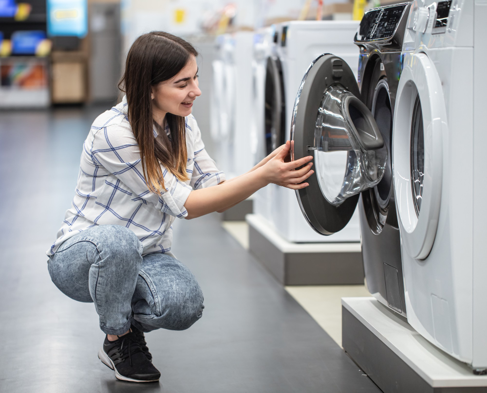 young woman store chooses washing machine concept shopping 1