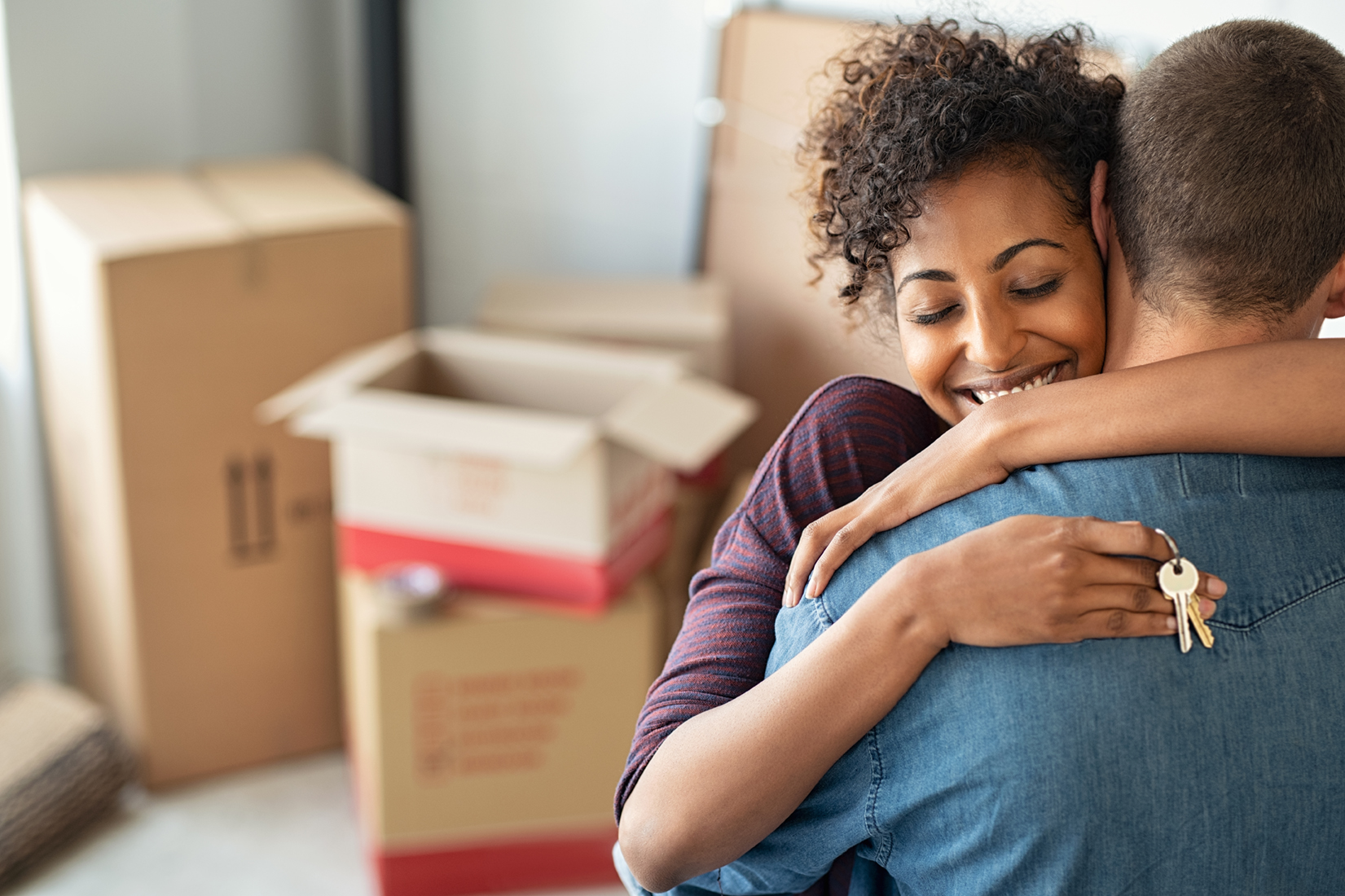 Woman hugging man and holding home keys 1158246435 6880x4584